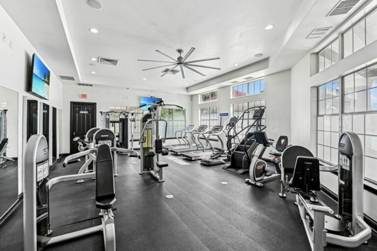 Modern fitness center with state-of-the-art equipment, sleek design, and ample natural light for an invigorating workout experience.